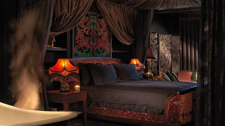 photo of four poster bed in a dark boutique room